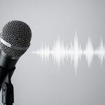 Close-up of a microphone with sound wave graphic, set against a neutral background.