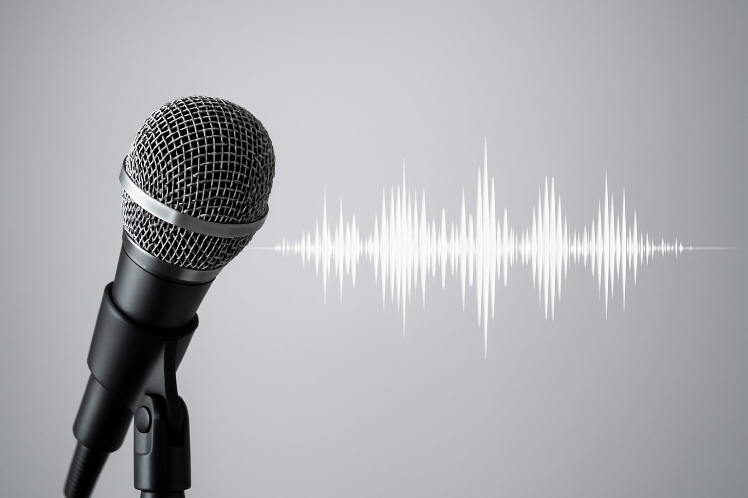 Close-up of a microphone with sound wave graphic, set against a neutral background.